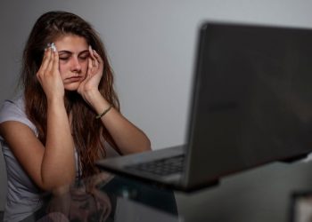 girl having headache due to excessive screen time