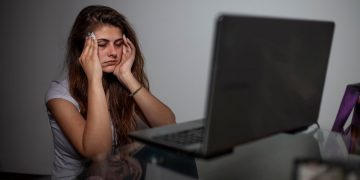 girl having headache due to excessive screen time