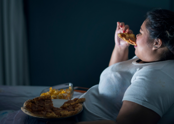 female eating abnormal amounts of food depicting Obesity