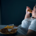 female eating abnormal amounts of food depicting Obesity